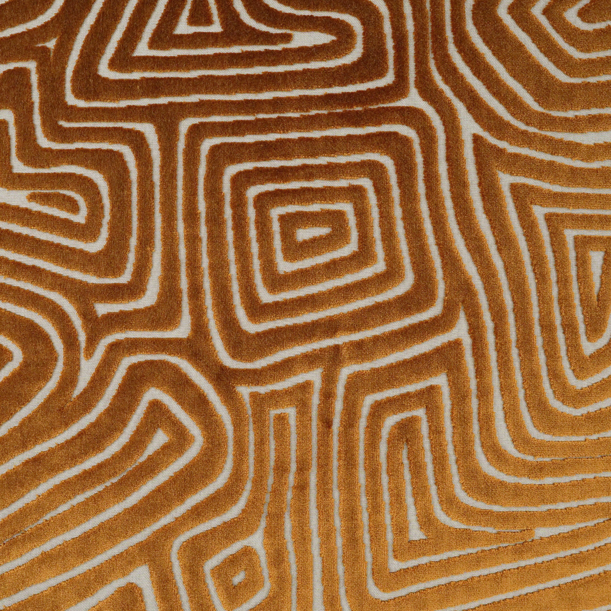 Orange-brown fabric featuring white concentric square maze pattern, geometric retro textile for upholstery or craft projects.