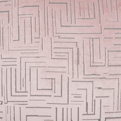 Soft pink fabric with gray labyrinth-spiral embroidery, geometric quilted pattern for upholstery or fashion accents.