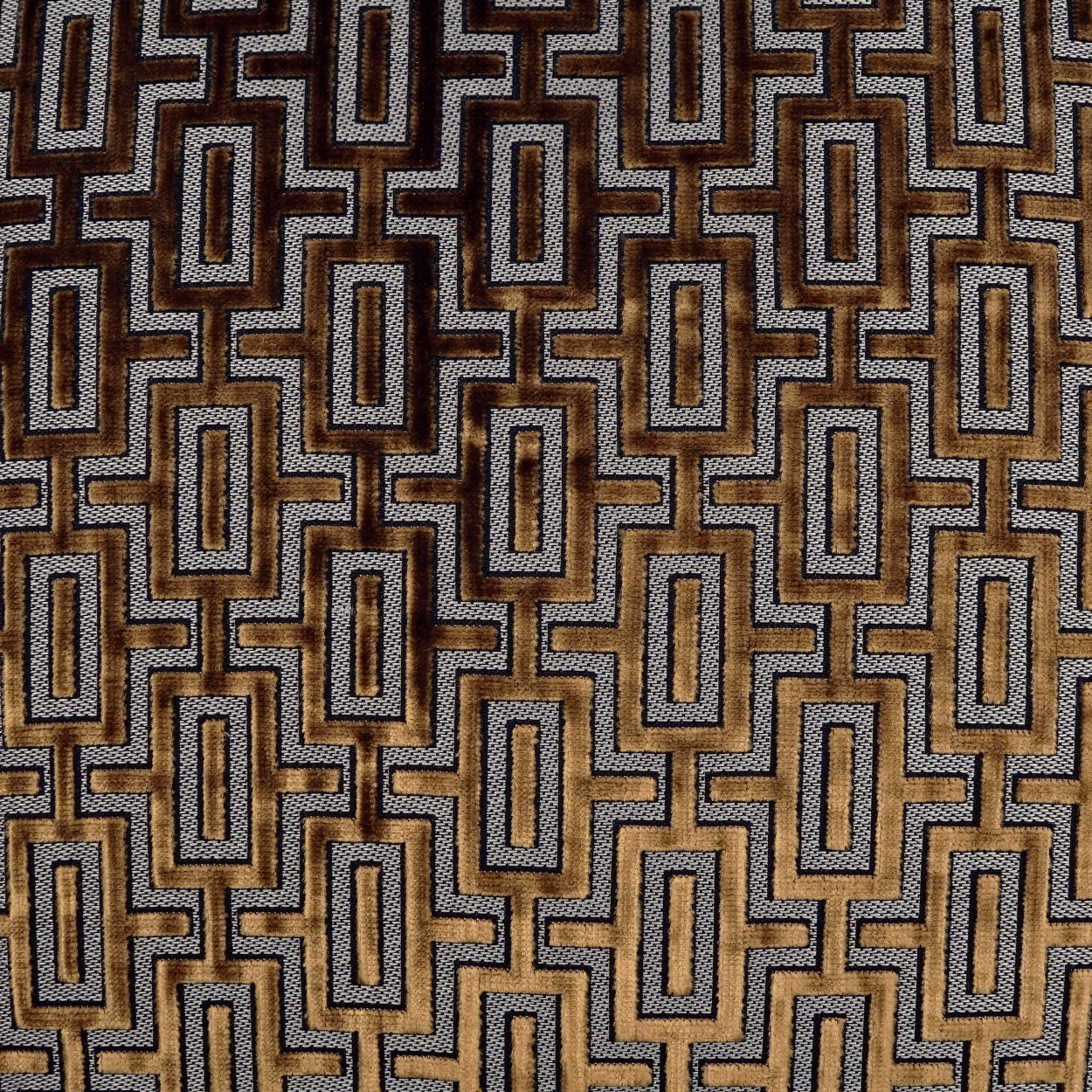 Upholstery fabric with a repeating geometric interlocking rectangle lattice in brown, tan and gold tones.