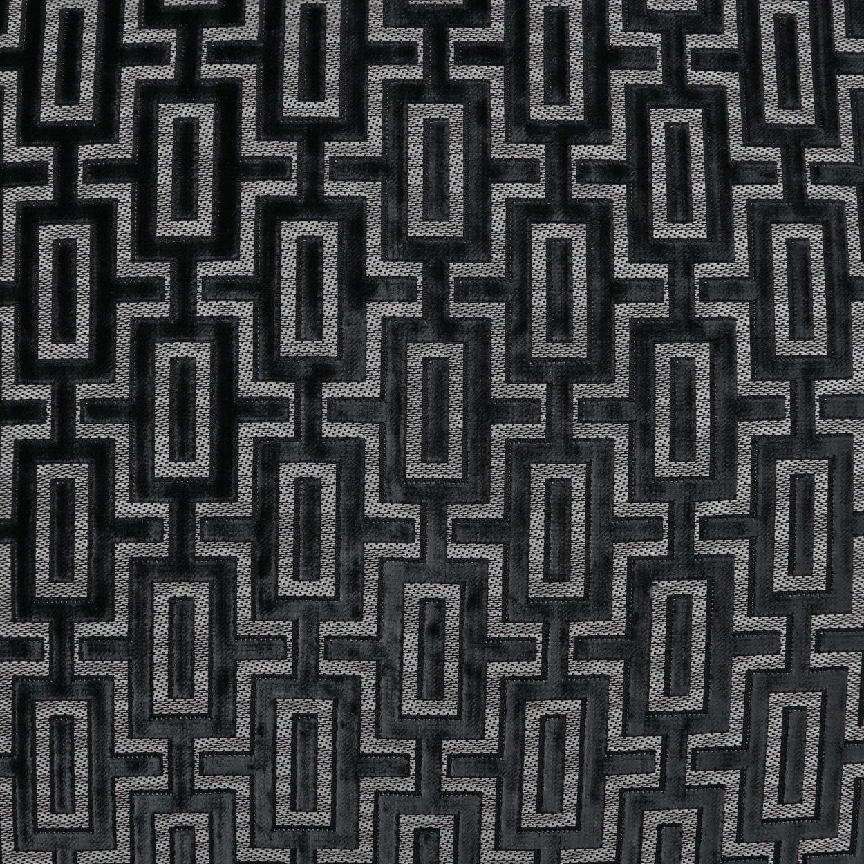 Gray and black geometric jacquard fabric with interlocking rectangle maze pattern, modern upholstery style.