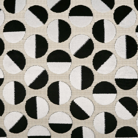 Beige woven fabric with a repeating black-and-white circle motif; each circle diagonally split into black and white halves.