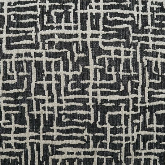 Woven black and white maze-pattern fabric with irregular white lines forming a geometric grid.