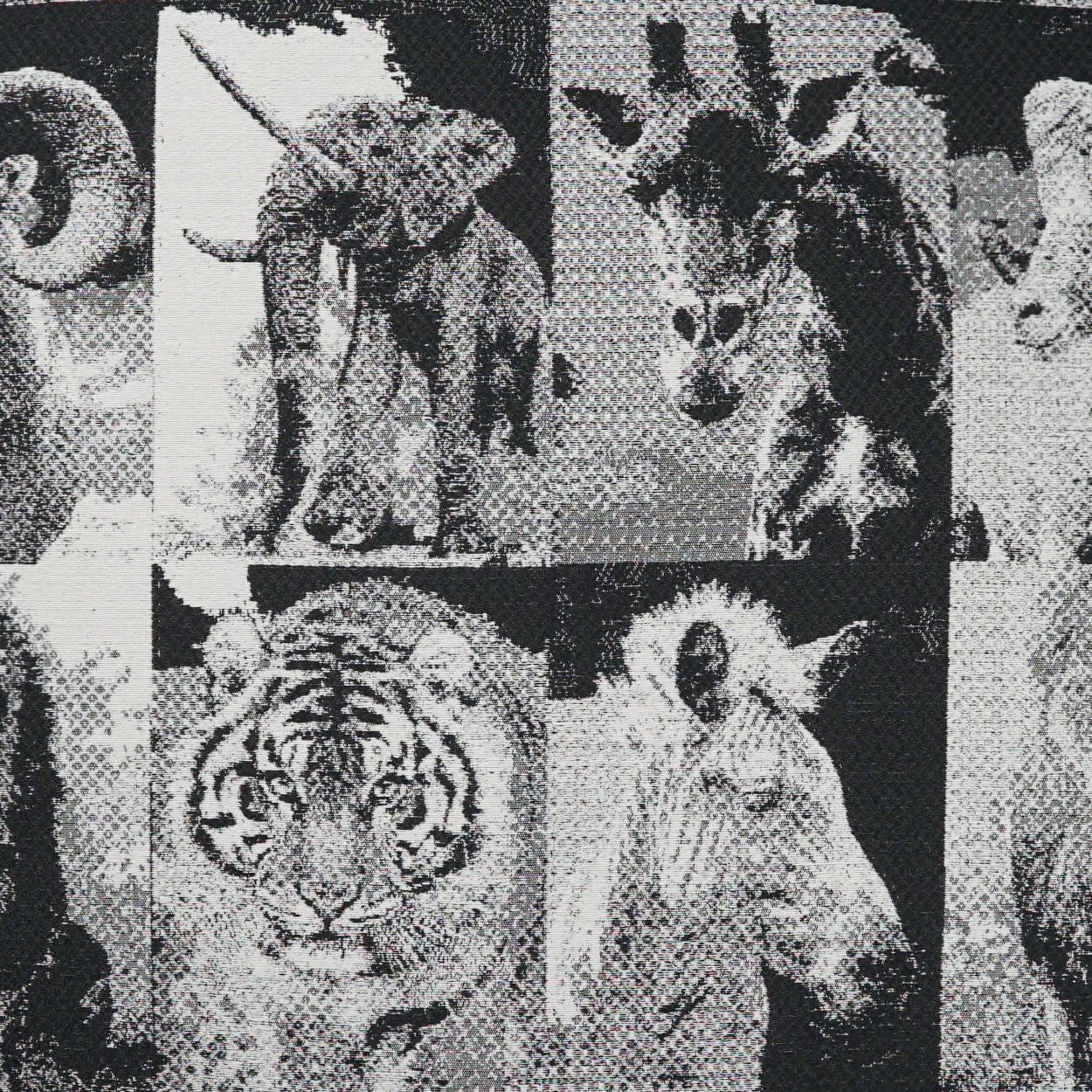 Monochrome fabric print with grayscale wildlife collage (tiger, elephant, zebra) in halftone style.