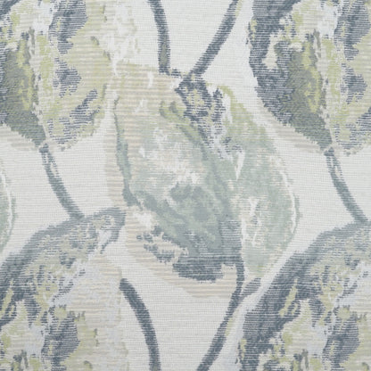 Decorative pillow with a muted botanical pattern of blue-gray and sage leaves on an ivory background.