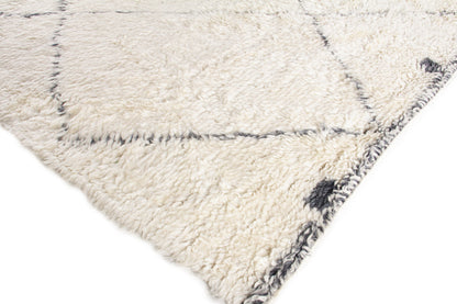 Cream shag rug with plush pile, gray grid pattern and dark edge border.