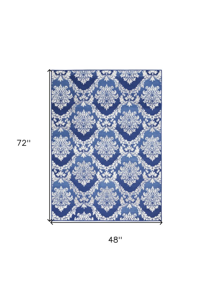 5' X 7' Blue And Ivory Damask Distressed Area Rug