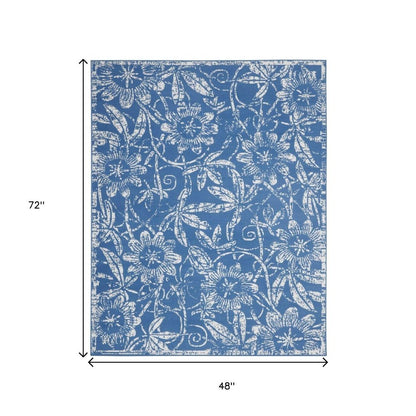 6' X 9' Blue And Ivory Floral Distressed Area Rug