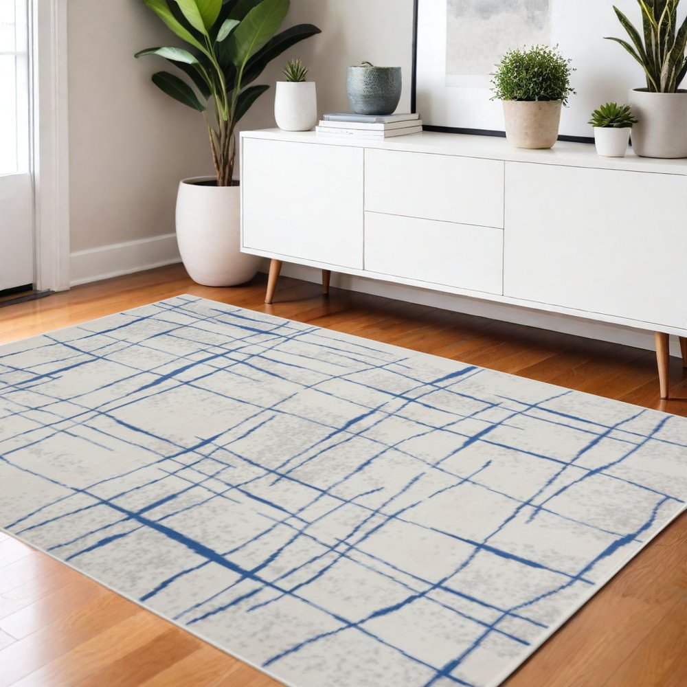 6' X 9' Ivory And Blue Geometric Distressed Area Rug