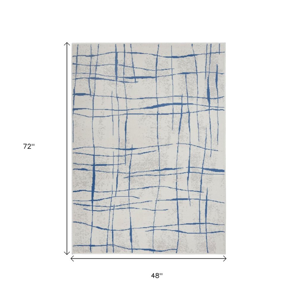6' X 9' Ivory And Blue Geometric Distressed Area Rug