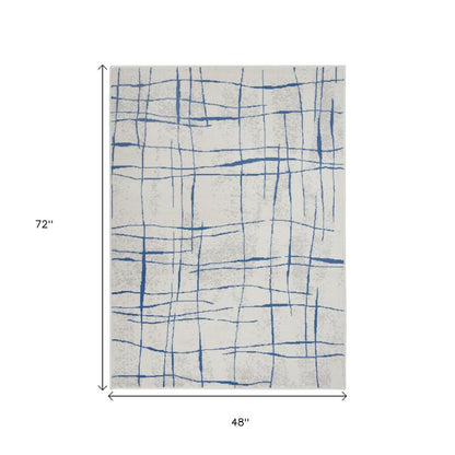 6' X 9' Ivory And Blue Geometric Distressed Area Rug