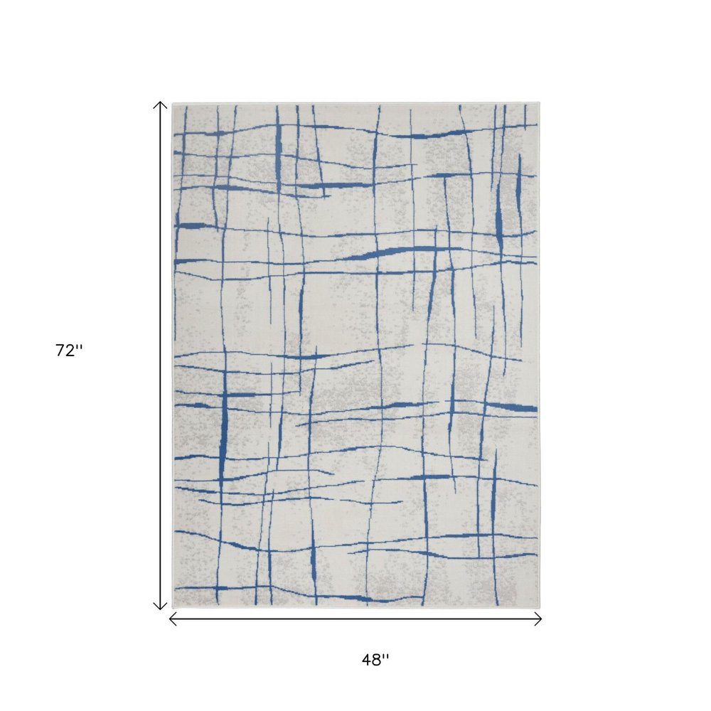 6' X 9' Ivory And Blue Geometric Distressed Area Rug