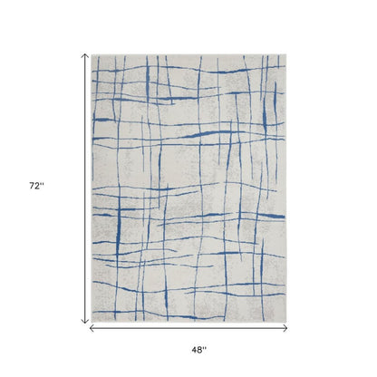 6' X 9' Ivory And Blue Geometric Distressed Area Rug