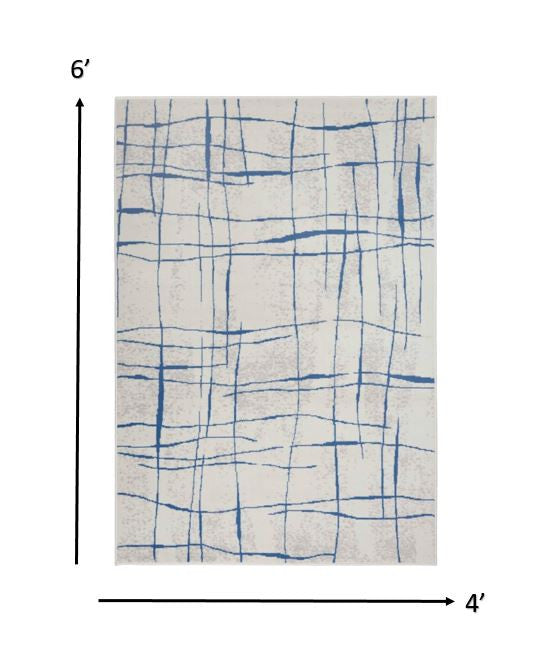 6' X 9' Blue And Ivory Abstract Dhurrie Area Rug