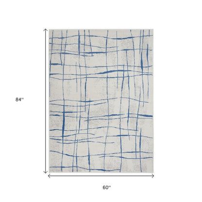 6' X 9' Ivory And Blue Geometric Distressed Area Rug