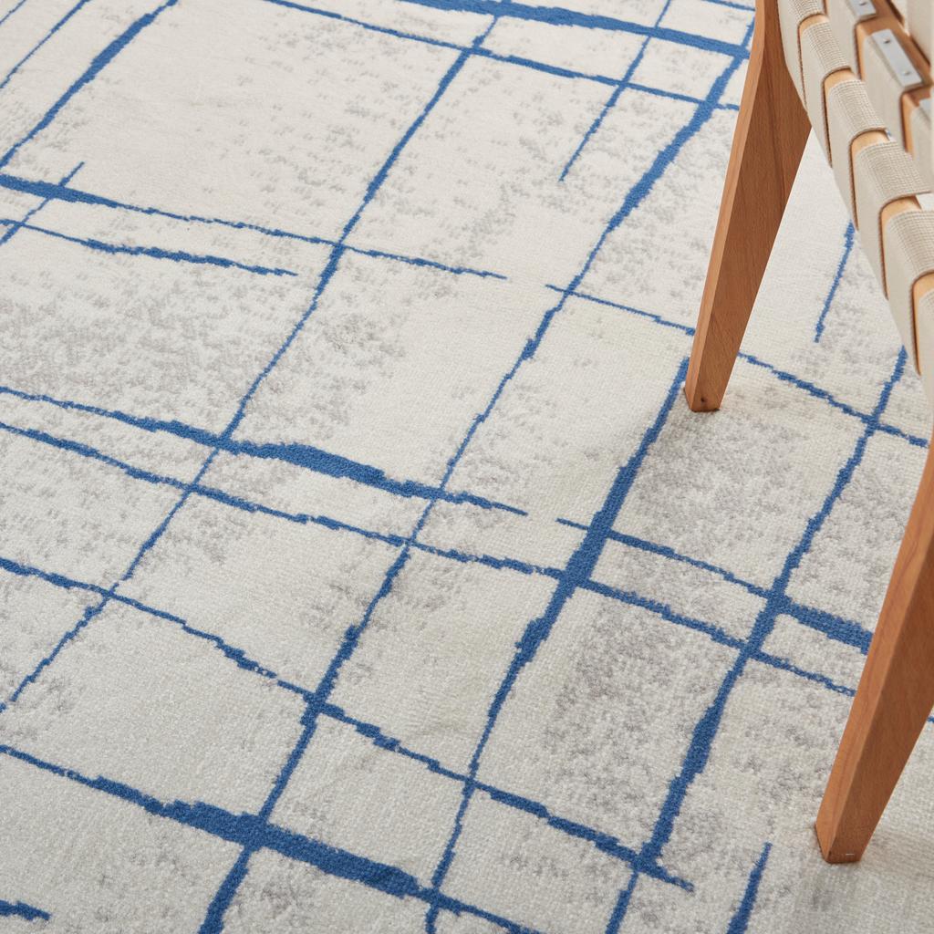 6' X 9' Blue And Ivory Abstract Dhurrie Area Rug