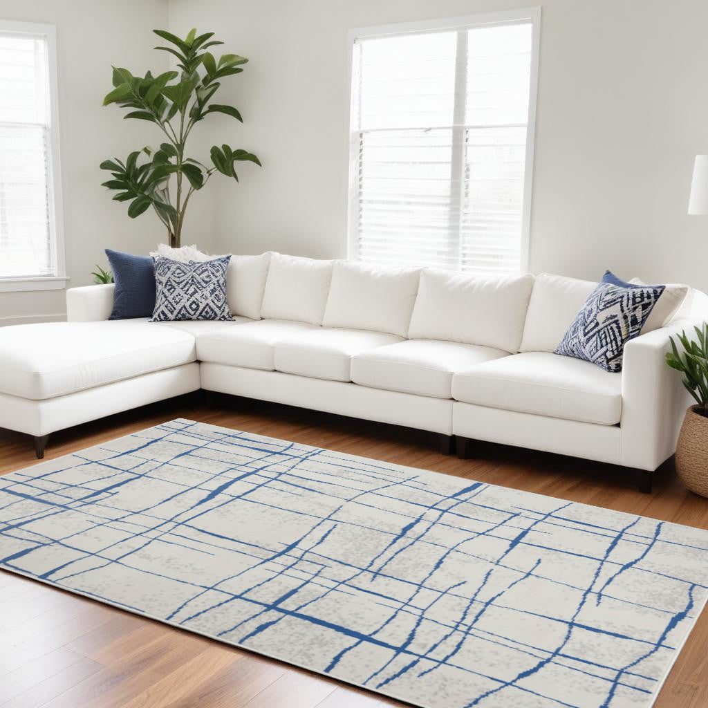 6' X 9' Blue And Ivory Abstract Dhurrie Area Rug