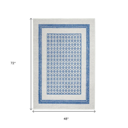 5' X 7' Ivory And Blue Geometric Area Rug