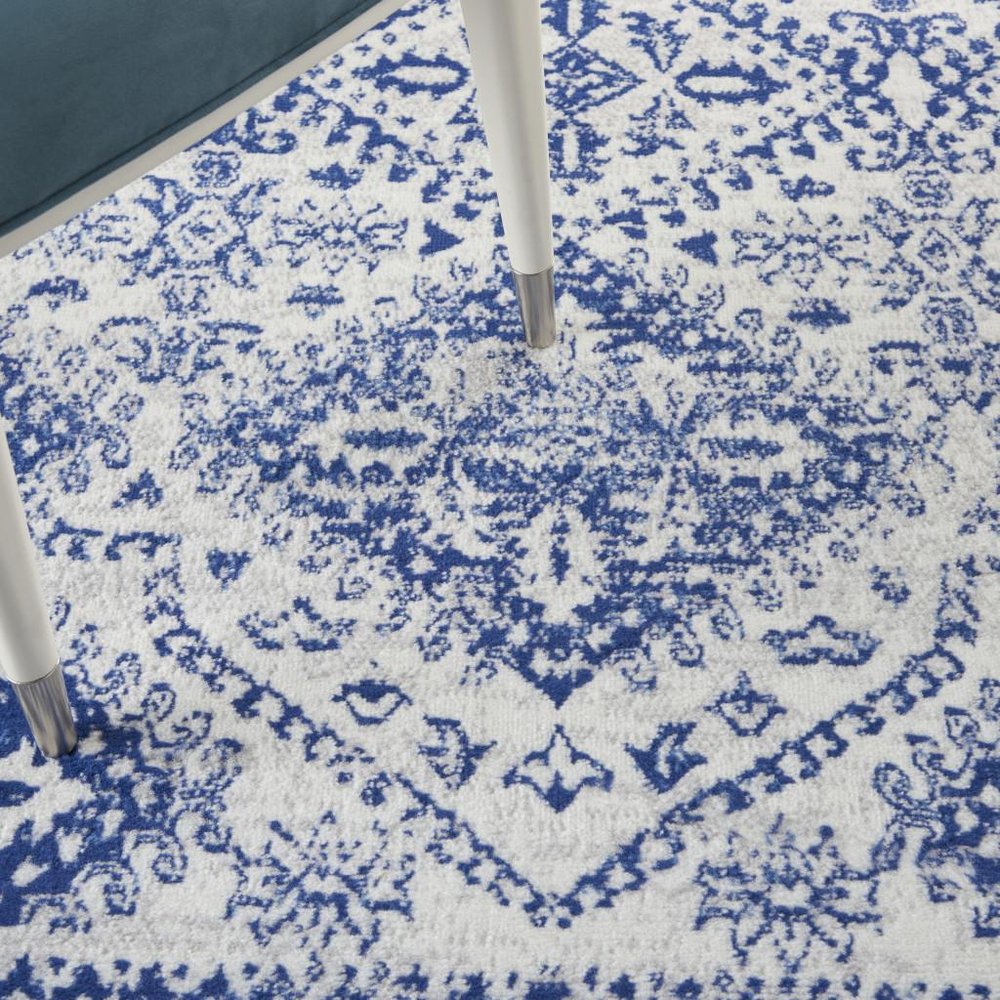 5' X 7' Ivory And Blue Geometric Distressed Area Rug