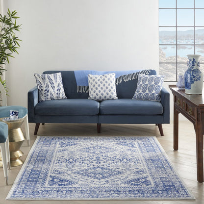 5' X 7' Ivory And Blue Geometric Distressed Area Rug