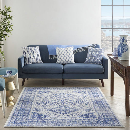 5' X 7' Ivory And Blue Geometric Distressed Area Rug