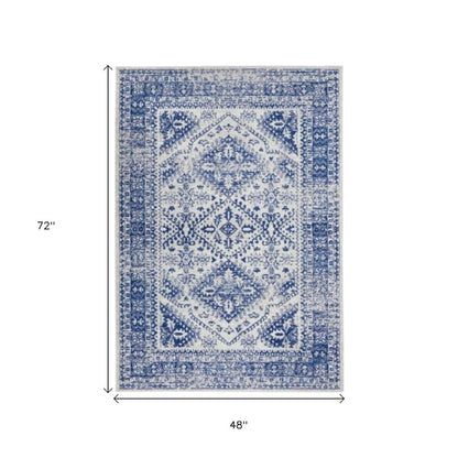 5' X 7' Ivory And Blue Geometric Distressed Area Rug