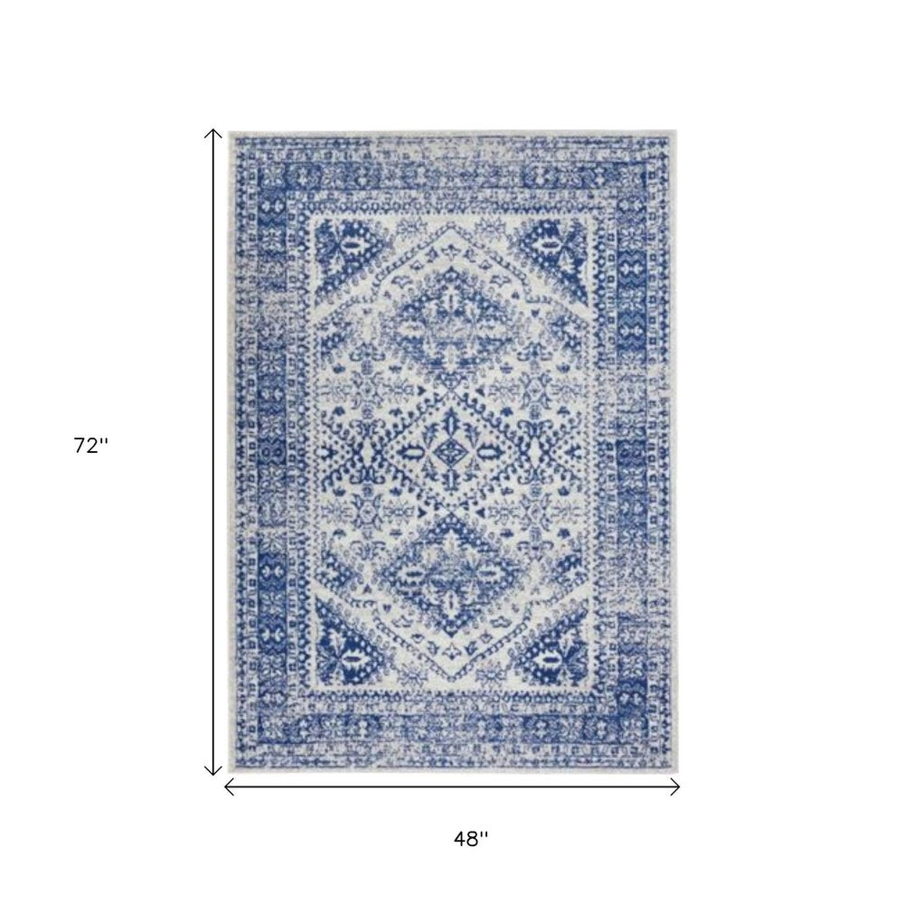 5' X 7' Ivory And Blue Geometric Distressed Area Rug