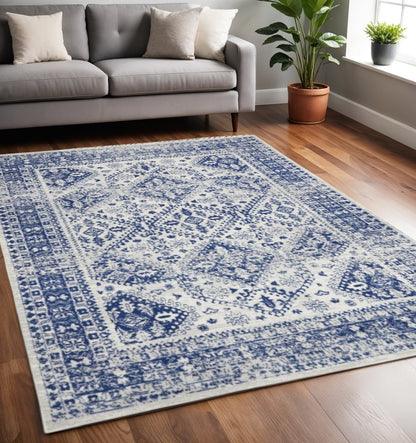 5' X 7' Ivory And Blue Geometric Distressed Area Rug