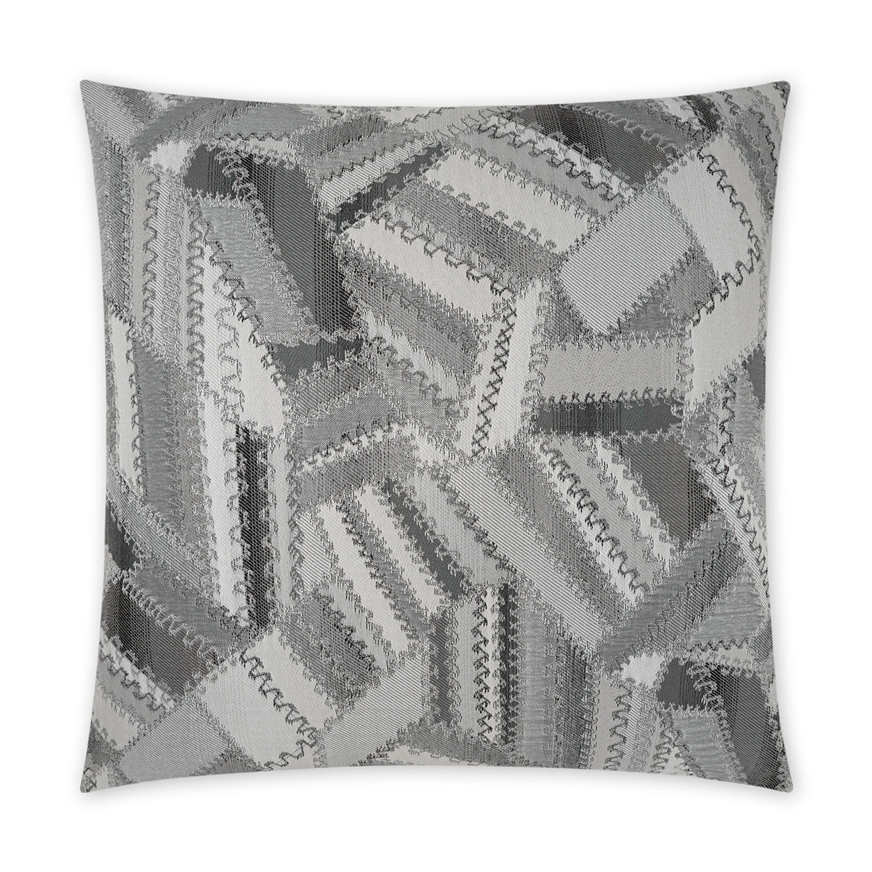 Square decorative pillow in charcoal-grey patchwork quilt design with zigzag stitched edges; modern monochrome throw pillow.