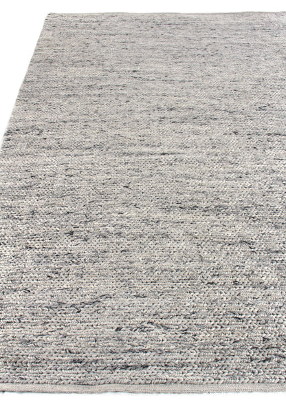 Gray speckled hand-woven rug with subtle blue/charcoal flecks; neutral, versatile living-room accent.
