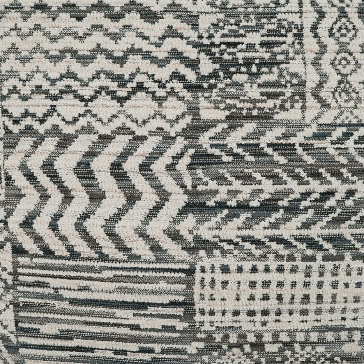 Grey, black and ivory geometric patchwork pillow, 24" x 24", with chevrons, zigzags and grid patterns; woven fabric.