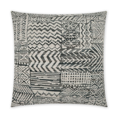 Square woven throw pillow in charcoal, white, gray patchwork geometric patterns; textured boho tribal style.