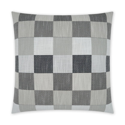 Square decorative pillow featuring grayscale checkerboard patchwork with varied textured fabrics.