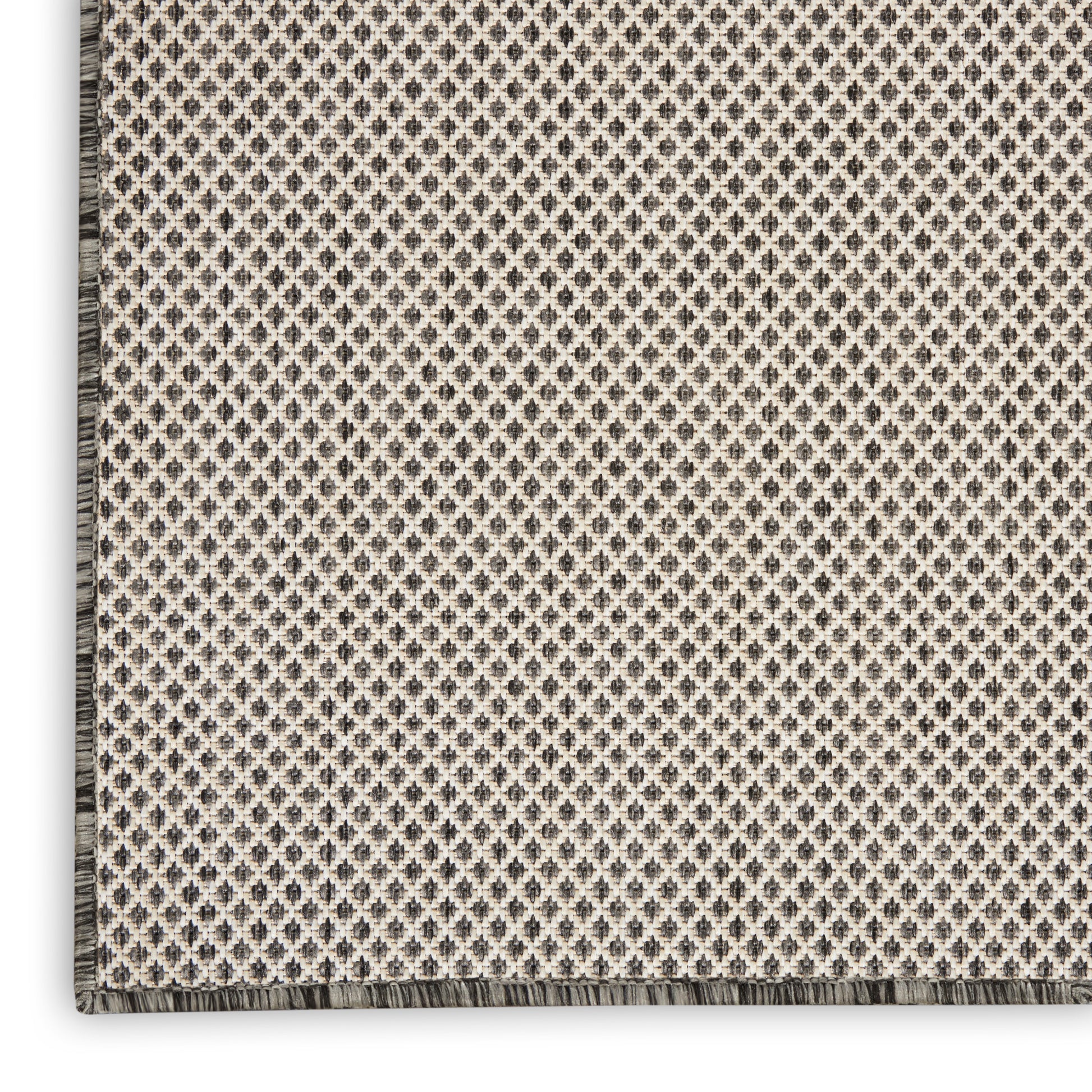 Beige flatwoven runner rug with a dark gray diamond lattice pattern & a fringed border.