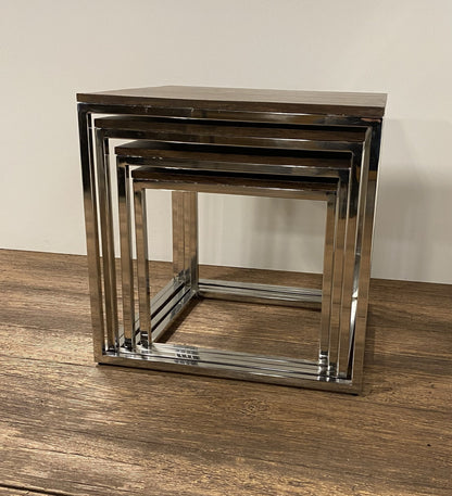 Set of four chrome nested square metal frames forming a modern geometric side table sculpture.