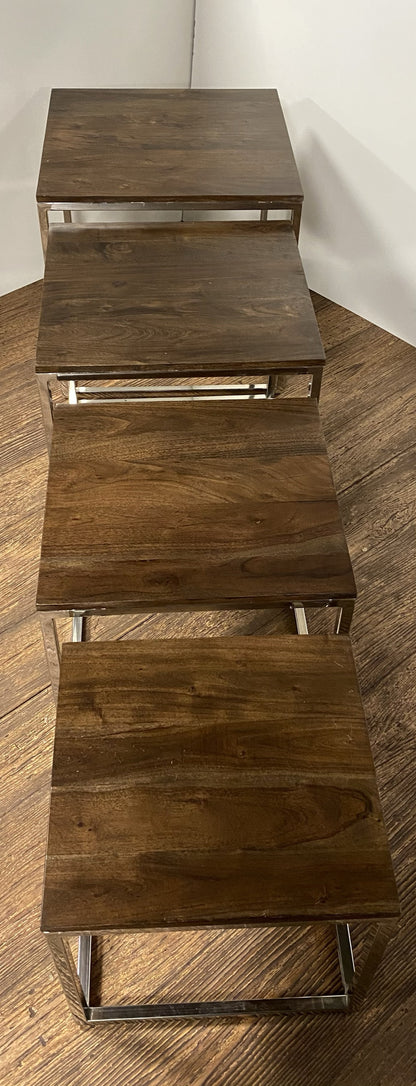 Four dark brown square wooden steps on slim metal frames, forming a modern nesting stair-step stool.