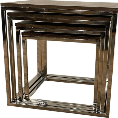 Set of nested square chrome metal side tables with a dark wood top, modern geometric nesting design.