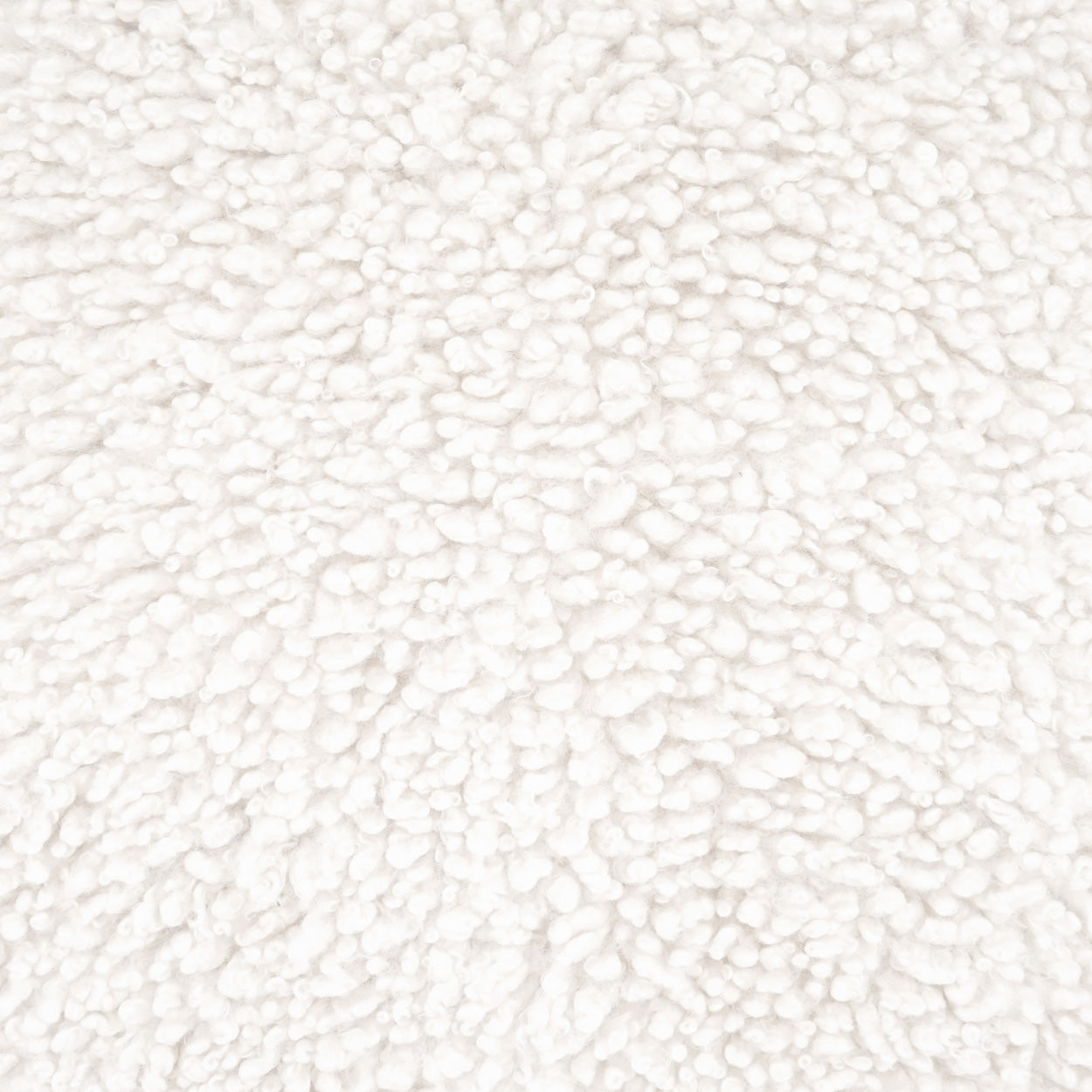 Cream faux fur pillow close-up with fluffy, plush pile.
