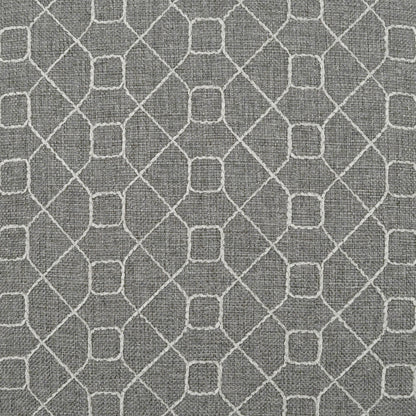 Grey pillow with textured fabric and a white geometric lattice pattern of interlocking diamonds & square nodes.