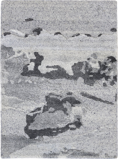 Gray-toned abstract seascape rug with rocky shoreline & waves, soft textured appearance.