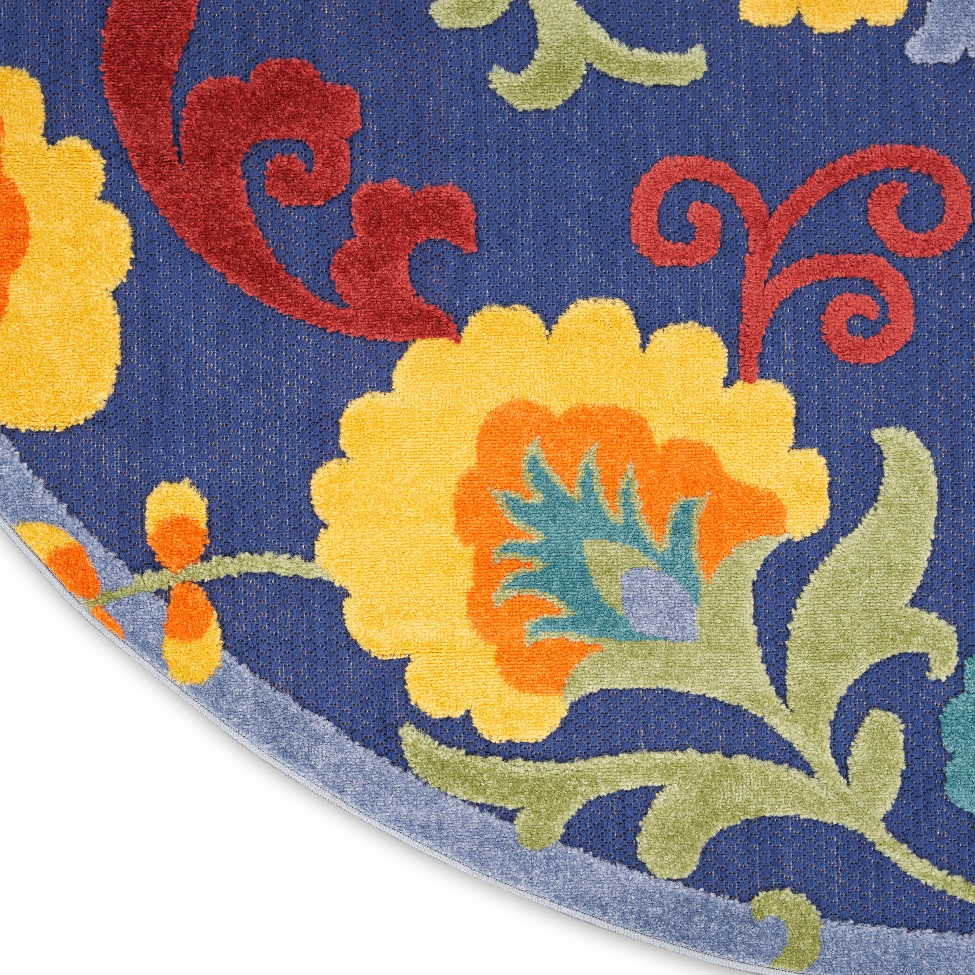 Blue floral outdoor round rug with yellow and orange flowers, red swirls, and green leaves; round shape, bold decorative pattern.