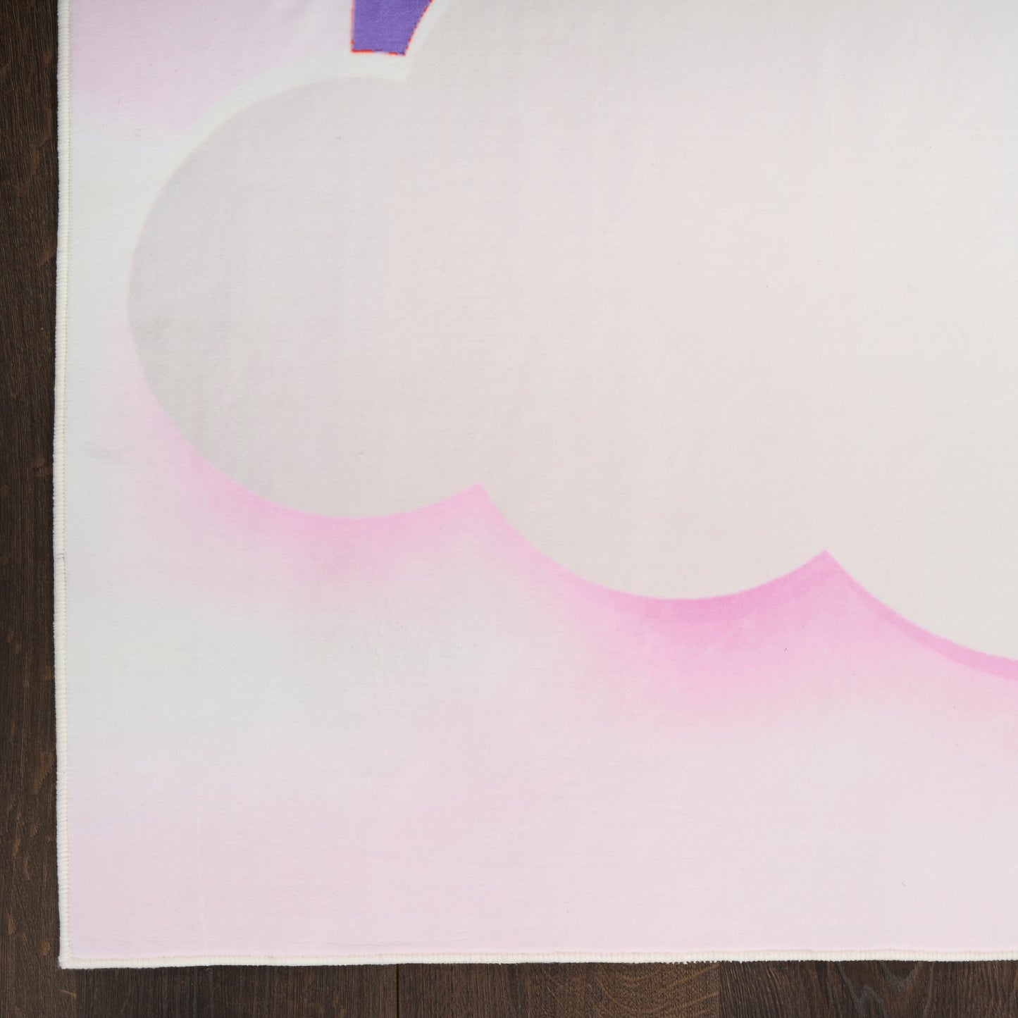 Pastel pink and white canvas with a pale cloud shape and pink gradient along bottom, resting on dark wooden floor.