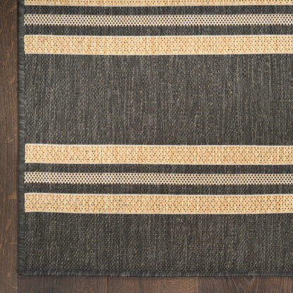 Dark charcoal flatweave rug with beige horizontal stripes and natural fiber texture, rectangular lounge floor mat.