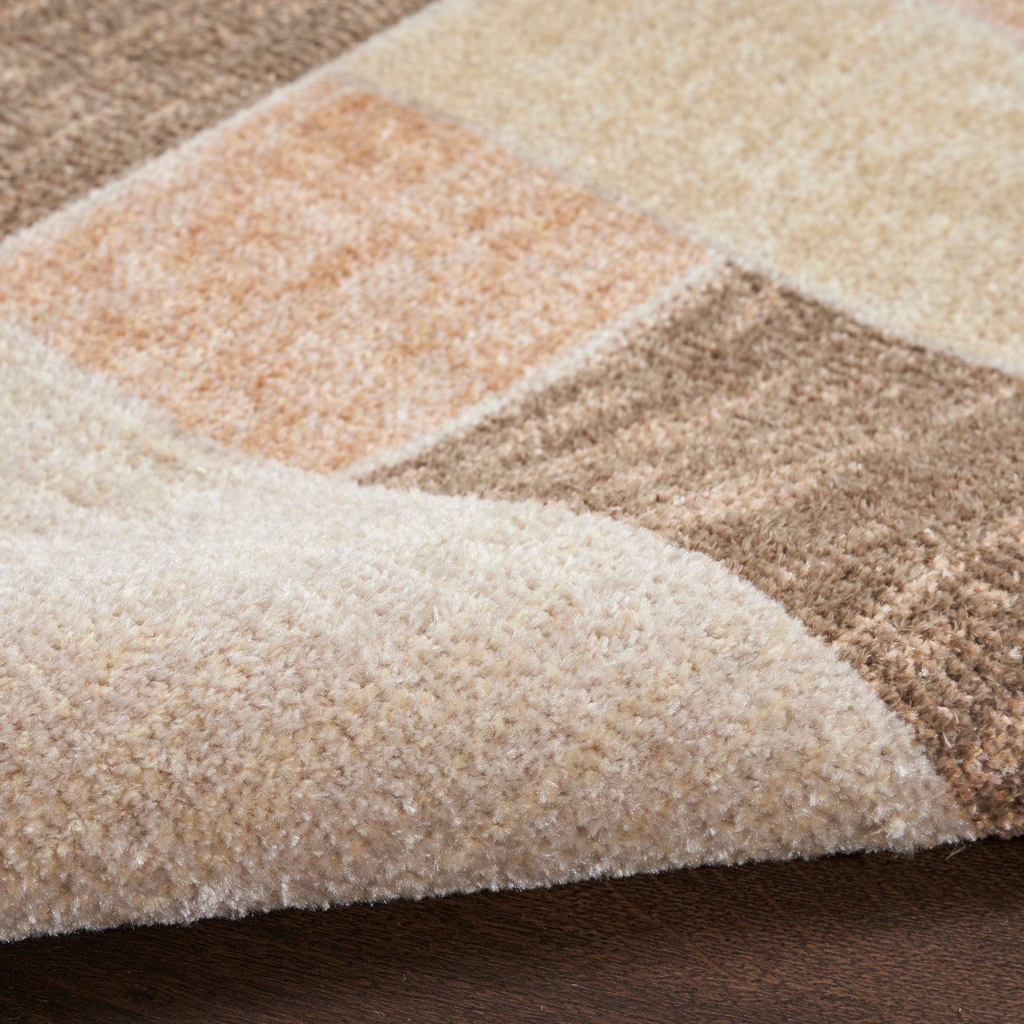 Soft patchwork shag rug in beige, cream, tan and brown with plush pile; cozy, warm home decor.