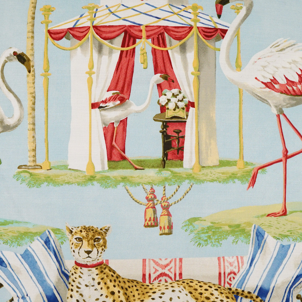 Light blue printed fabric with leopard, cranes, a decorative gazebo with red drapes, tassels, and blue striped cushions.
