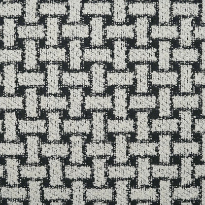 Black and white woven pillow with a basketweave texture; chunky white yarns create a bold geometric pattern.