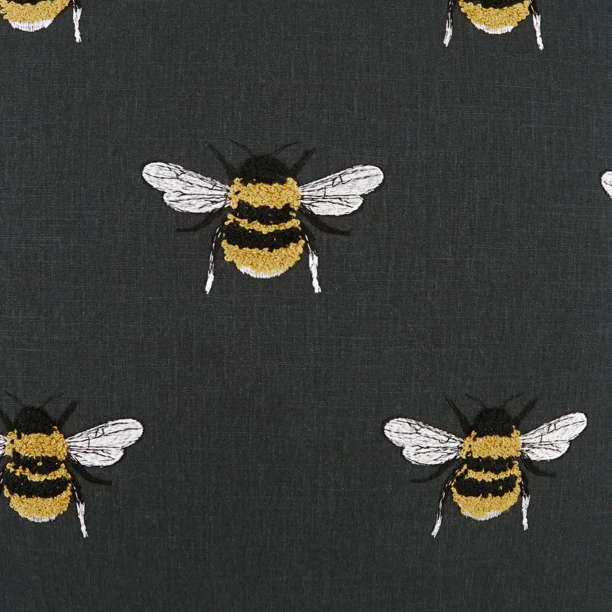 Charcoal fabric with repeating embroidered bees in yellow and black with white wings.
