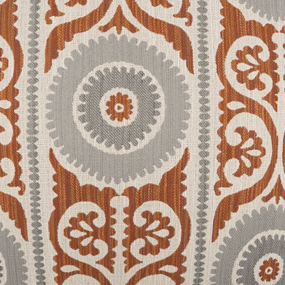 Rust-orange and gray damask pattern with circular rosettes and ornate scrolling motifs on a cream background, shown on a pillow.