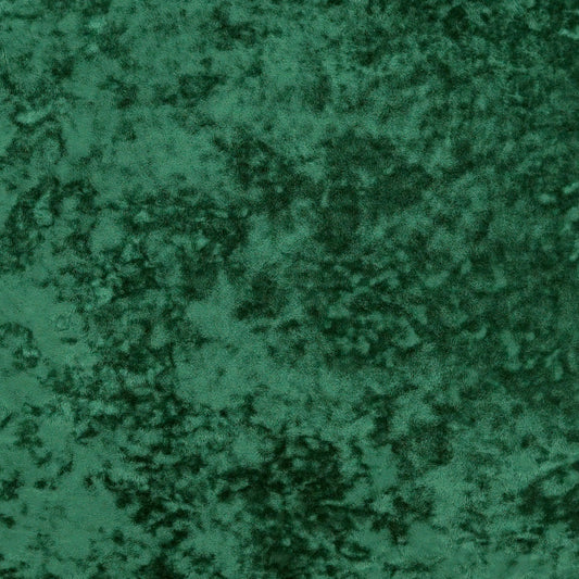 Emerald green crushed velvet fabric texture with mottled dark and light areas.