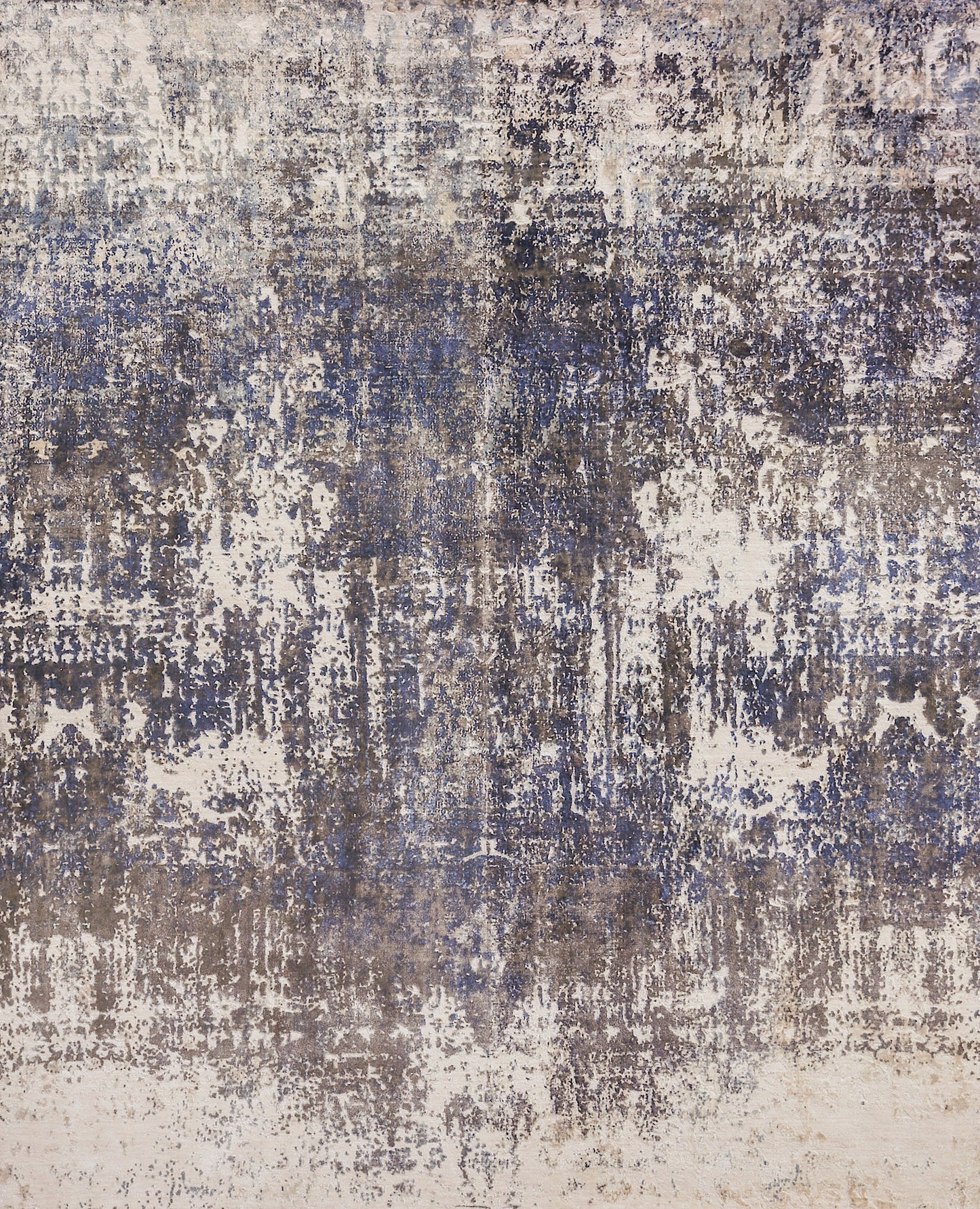 Abstract distressed area rug in blue, gray, and beige with a weathered, painterly pattern.