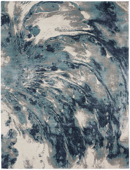 Rectangular abstract blue & white marbled rug with teal & navy swirls; plush, modern decor piece.